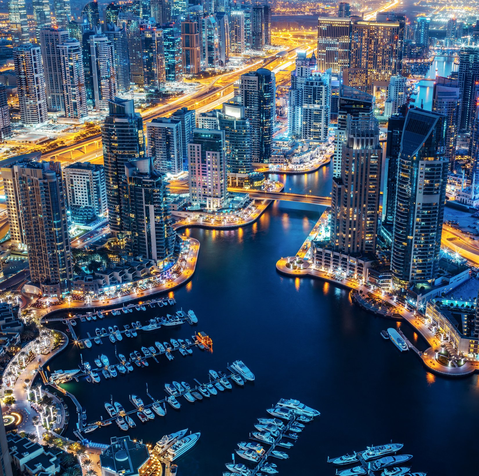 Illuminated architecture of Dubai by night. Scenic skyline.